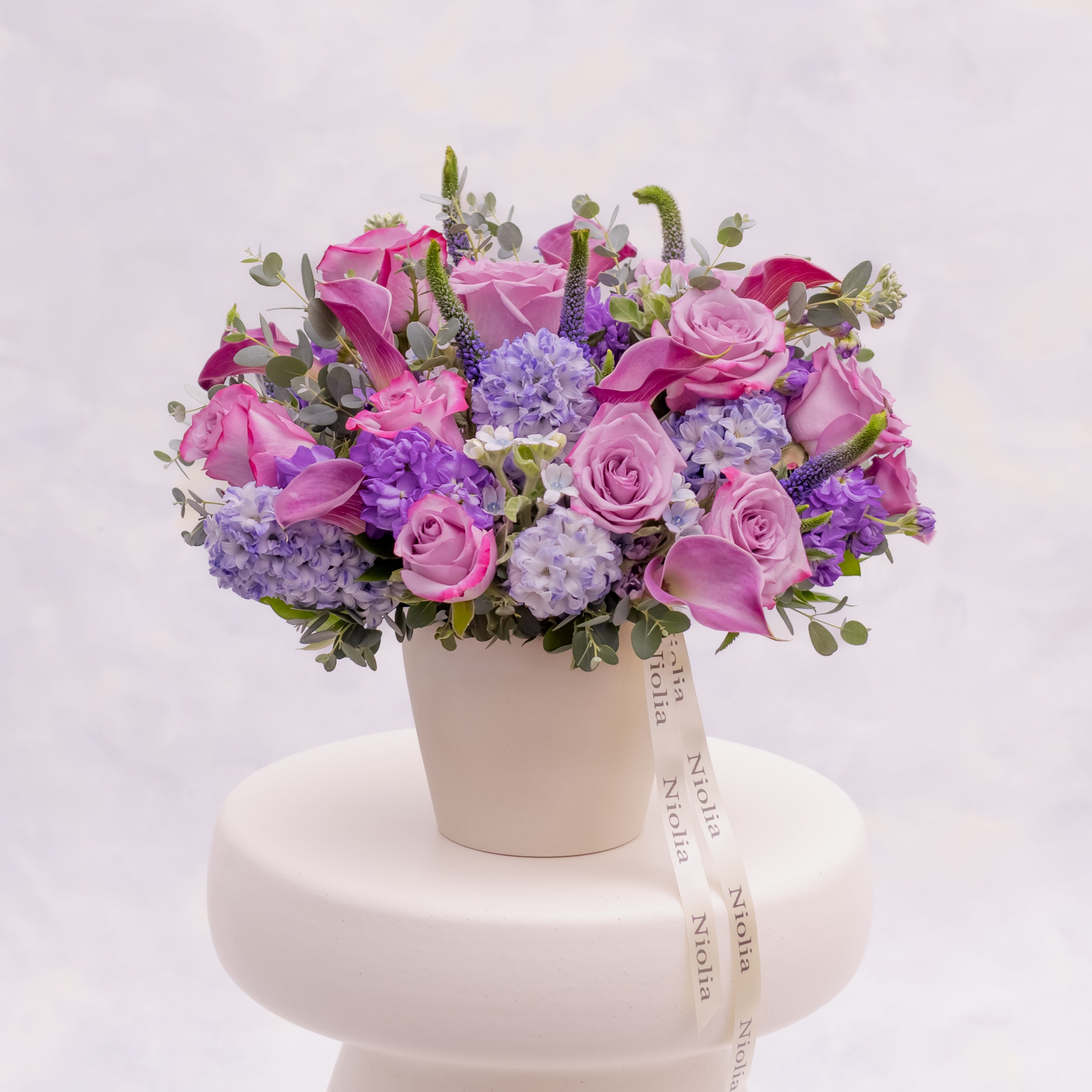 Lavender garden-style flower arrangement with roses and hyacinth by Niolia Flowers, luxury flower delivery in San Francisco.