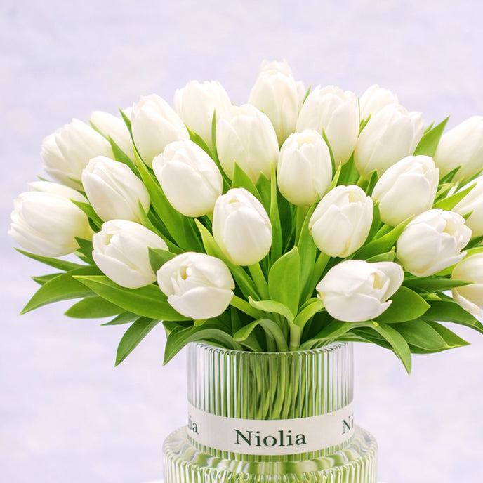 Classic white tulip flower arrangement  featuring white tulips arranged in a modern glass vase by Niolia, San Francisco florist

