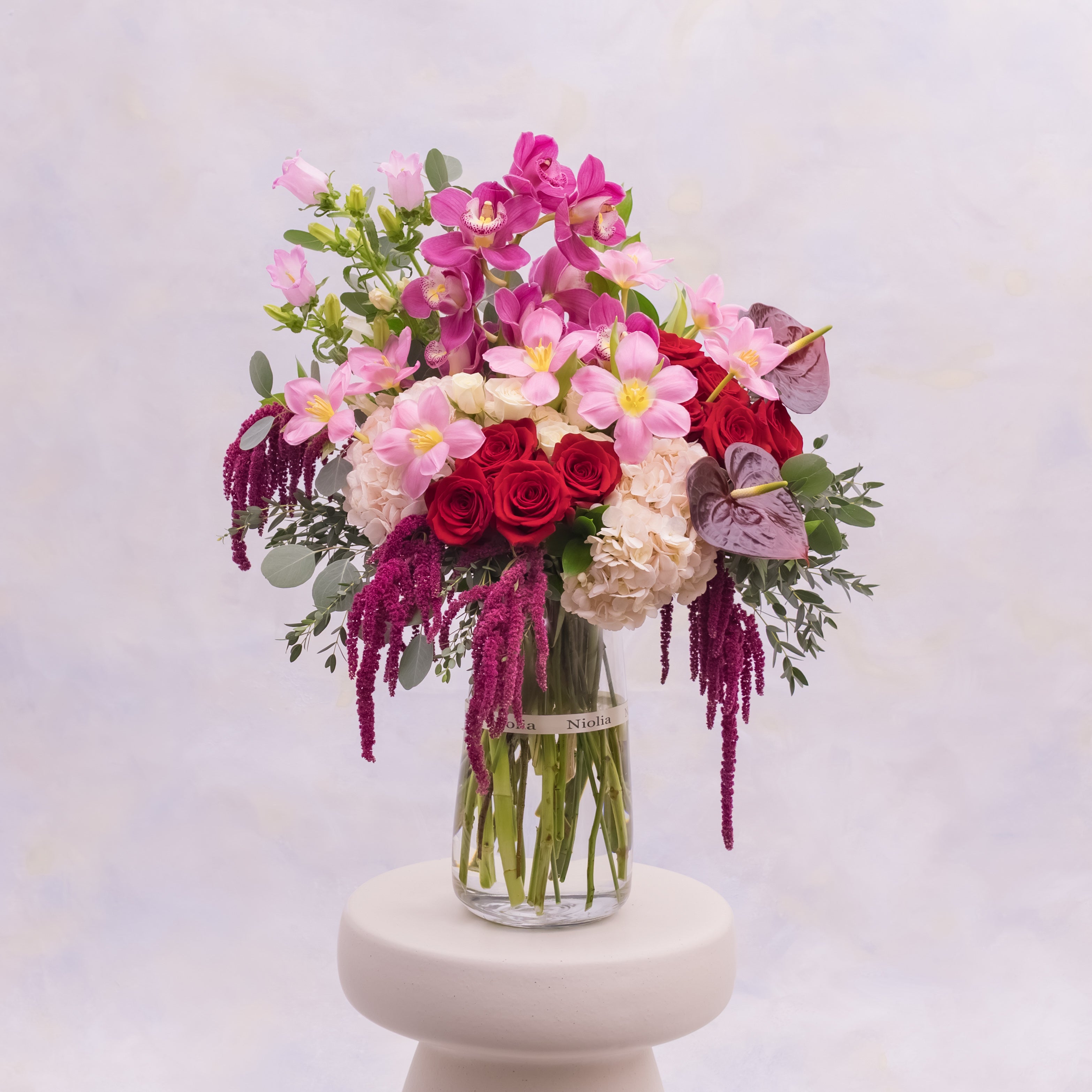 Grand luxury rose and orchid flower arrangement is a statement floral composition designed to command attention leave a lasting impression. Flower selection: red roses, cymbidium orchids, tulips, hydrangeas, anthuriums, amaranth, and seasonal greenery. Available for same-day flower delivery in San Francisco and Bay Area cities. 