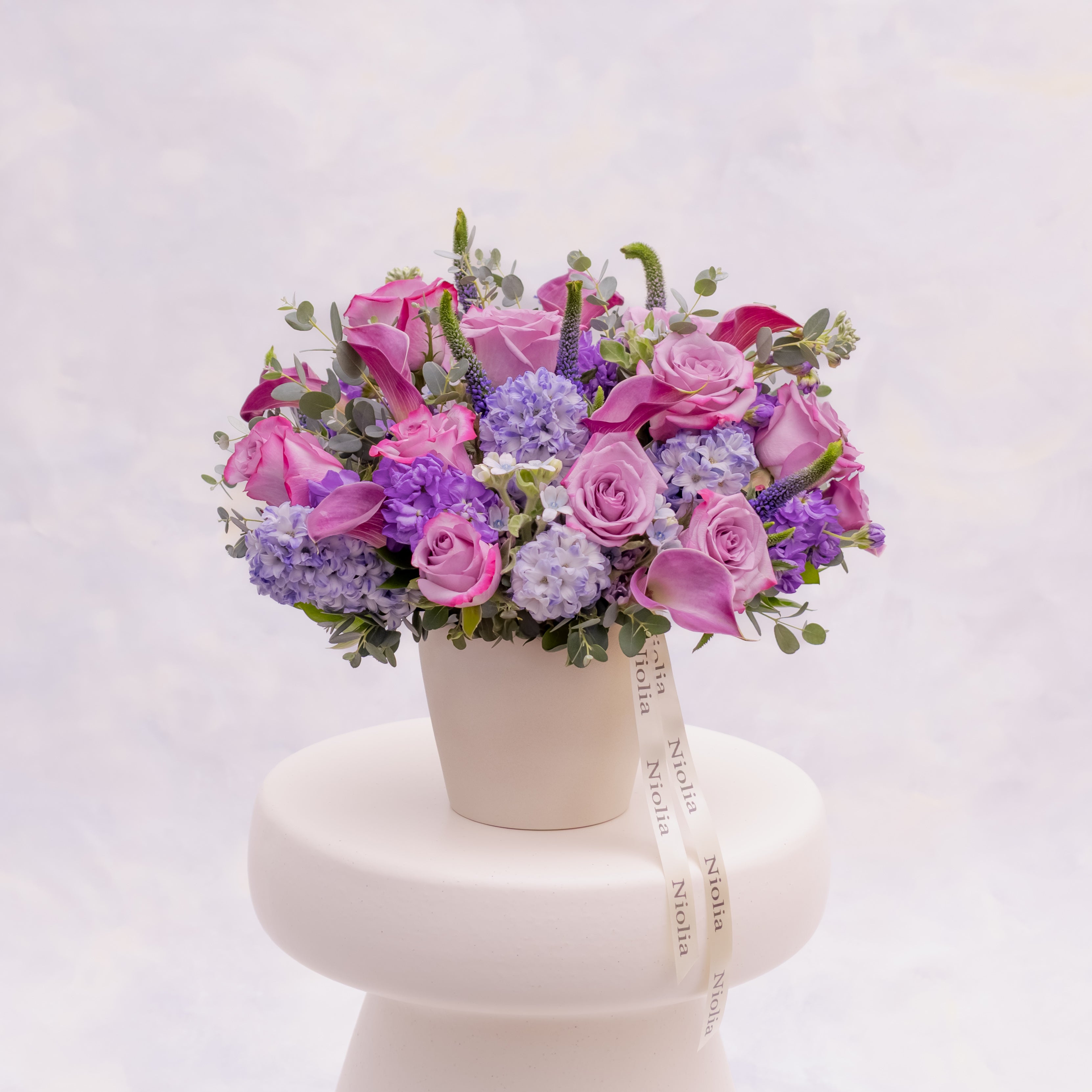 Lavender garden style flower arrangement with roses and hyacinth by Niolia Flowers, luxury flower delivery in San Francisco.